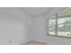 Bright bedroom with large window offering natural light and neutral colored walls with wood flooring at 13303 Swiftwater Way, Lakewood Ranch, FL 34211