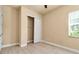 Bright bedroom featuring a closet with sliding doors, light wood floors, and natural light at 13303 Swiftwater Way, Lakewood Ranch, FL 34211