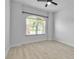 Bright, airy bedroom with ceiling fan and a large window offering scenic outdoor views and natural light at 13303 Swiftwater Way, Lakewood Ranch, FL 34211
