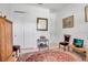 Bright bedroom featuring white doors, light wood floors, and a decorative carpet at 13303 Swiftwater Way, Lakewood Ranch, FL 34211