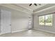 Bright bedroom with light wood flooring, large window, and neutral walls at 13303 Swiftwater Way, Lakewood Ranch, FL 34211