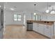 Open concept kitchen with granite countertops, stainless steel dishwasher, and bright natural light coming from the breakfast nook at 13303 Swiftwater Way, Lakewood Ranch, FL 34211