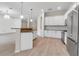 Spacious kitchen with granite countertops, stainless steel appliances, and a breakfast bar at 13303 Swiftwater Way, Lakewood Ranch, FL 34211