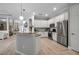 Modern kitchen with white cabinets, stainless steel appliances, and granite countertops at 13303 Swiftwater Way, Lakewood Ranch, FL 34211