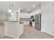 Modern kitchen featuring stainless steel appliances, white cabinetry, and stylish lighting at 13303 Swiftwater Way, Lakewood Ranch, FL 34211