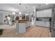 Open concept kitchen with stainless steel appliances, a breakfast bar and a view into the living room at 13303 Swiftwater Way, Lakewood Ranch, FL 34211