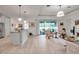 Spacious living room showcasing light wood floors, bright lighting, and an open layout with access to the patio at 13303 Swiftwater Way, Lakewood Ranch, FL 34211