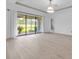 Bright, unfurnished living room with sliding glass doors opening to the outdoors and light wood floors at 13303 Swiftwater Way, Lakewood Ranch, FL 34211