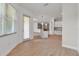 Open-concept living space featuring wood flooring, natural light, and a kitchen with an island for extra cooking and counter space at 13303 Swiftwater Way, Lakewood Ranch, FL 34211