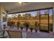Covered and screened patio featuring brick pavers, flower pots, and outdoor furniture at 13303 Swiftwater Way, Lakewood Ranch, FL 34211