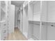 Spacious walk-in closet with custom shelving and rods for optimal organization and storage at 13303 Swiftwater Way, Lakewood Ranch, FL 34211