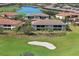 Scenic aerial view of the community showcasing the golf course, lush greenery, and well-manicured landscaping at 13816 Messina Loop # 104, Bradenton, FL 34211
