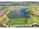 Aerial view of home community with lake, golf course, and driving range at 13816 Messina Loop # 104, Bradenton, FL 34211