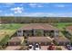 An aerial view of condos and garages with brick driveways, set against a background of green trees and a blue sky at 13816 Messina Loop # 104, Bradenton, FL 34211