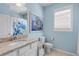 Nautical themed bathroom with a turtle shower curtain and fish artwork above the toilet at 13816 Messina Loop # 104, Bradenton, FL 34211