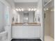Bright bathroom with granite countertops, double sinks, and a glass door shower at 13816 Messina Loop # 104, Bradenton, FL 34211