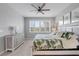 Bright bedroom with tropical-themed bedspread, ceiling fan and shuttered windows that let in natural light at 13816 Messina Loop # 104, Bradenton, FL 34211