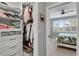 Organized walk-in closet adjacent to a bedroom with shelving, drawers, and clothing racks at 13816 Messina Loop # 104, Bradenton, FL 34211
