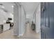 Hallway with tile flooring and a view of the kitchen, living room, and front door at 13816 Messina Loop # 104, Bradenton, FL 34211