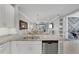 Open kitchen flows into dining area, featuring granite counters and stainless appliances at 13816 Messina Loop # 104, Bradenton, FL 34211