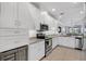 Modern kitchen featuring stainless appliances, granite countertops, and white cabinetry at 13816 Messina Loop # 104, Bradenton, FL 34211