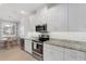 Bright kitchen features white cabinets, stainless appliances, and view to the breakfast nook at 13816 Messina Loop # 104, Bradenton, FL 34211
