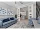 Cozy living room with blue sofa, patterned chair, and view into the kitchen at 13816 Messina Loop # 104, Bradenton, FL 34211