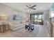 Comfortable living room with glass coffee table, neutral tones, sliding glass doors to patio, and stylish decor at 13816 Messina Loop # 104, Bradenton, FL 34211