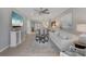 Open-concept living space with modern decor, including a large painting, TV, and comfortable seating at 13816 Messina Loop # 104, Bradenton, FL 34211