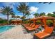 Luxurious poolside cabanas with comfortable seating, perfect for relaxing by the pool at 13816 Messina Loop # 104, Bradenton, FL 34211