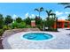 Community spa with water feature surrounded by tropical landscaping at 13816 Messina Loop # 104, Bradenton, FL 34211