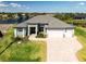 Aerial view of a stunning single-Gathering home overlooking a serene lake at 15170 Altura Rd, Port Charlotte, FL 33981