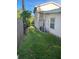 Manicured side yard featuring green grass and fencing at 1804 Baywood Dr, Sarasota, FL 34231