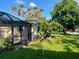 View of pool enclosure, greenery and side yard at 1804 Baywood Dr, Sarasota, FL 34231