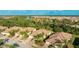 Aerial view of a residential community with lush landscaping and tile roofs at 20170 Benissimo Dr, Venice, FL 34293