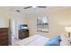 Bedroom featuring a bed, natural lighting through a window, and TV at 20170 Benissimo Dr, Venice, FL 34293