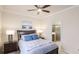 Bedroom featuring a bed with nightstands and lamps, with an open view to an en-suite bathroom at 20170 Benissimo Dr, Venice, FL 34293