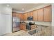 Kitchen featuring stainless steel appliances, light wood cabinets, granite countertops, and tile floors at 20170 Benissimo Dr, Venice, FL 34293