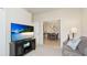 Bright living room featuring a large TV screen and view to dining room with modern decor at 20170 Benissimo Dr, Venice, FL 34293