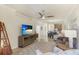 Open-concept living room with tile flooring, ceiling fan, and a view of the dining area at 20170 Benissimo Dr, Venice, FL 34293