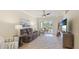 Comfortable living room with a large sliding glass door leading to the outdoors at 20170 Benissimo Dr, Venice, FL 34293