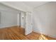 Bedroom with beautiful wood floors featuring an open door to an adjacent room at 210 N 17Th W St # 12, Bradenton, FL 34205