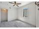 Cozy bedroom featuring a ceiling fan, grey carpet, and a bright window at 210 N 17Th W St # 12, Bradenton, FL 34205
