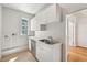Bright kitchen features white cabinets, stainless steel appliances, and a double basin sink at 210 N 17Th W St # 12, Bradenton, FL 34205