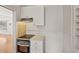 This kitchen features a stainless steel oven and range top below white cabinets at 210 N 17Th W St # 12, Bradenton, FL 34205