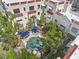 Aerial view of a community pool surrounded by lounge chairs and lush landscaping at 210 N 17Th W St # 12, Bradenton, FL 34205