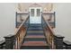 Interior staircase with iron railings and decorative sconces on a landing at 210 N 17Th W St # 12, Bradenton, FL 34205