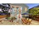 Outdoor dining area beside stairs leading to upper floor unit at 310 S Osprey Ave, Sarasota, FL 34236