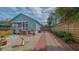 Inviting backyard featuring a brick-lined driveway, quaint patio area, and privacy fence for outdoor enjoyment at 310 S Osprey Ave, Sarasota, FL 34236