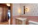 Bathroom featuring vintage tile flooring, pink wall accents, and stylish floral wallpaper at 310 S Osprey Ave, Sarasota, FL 34236